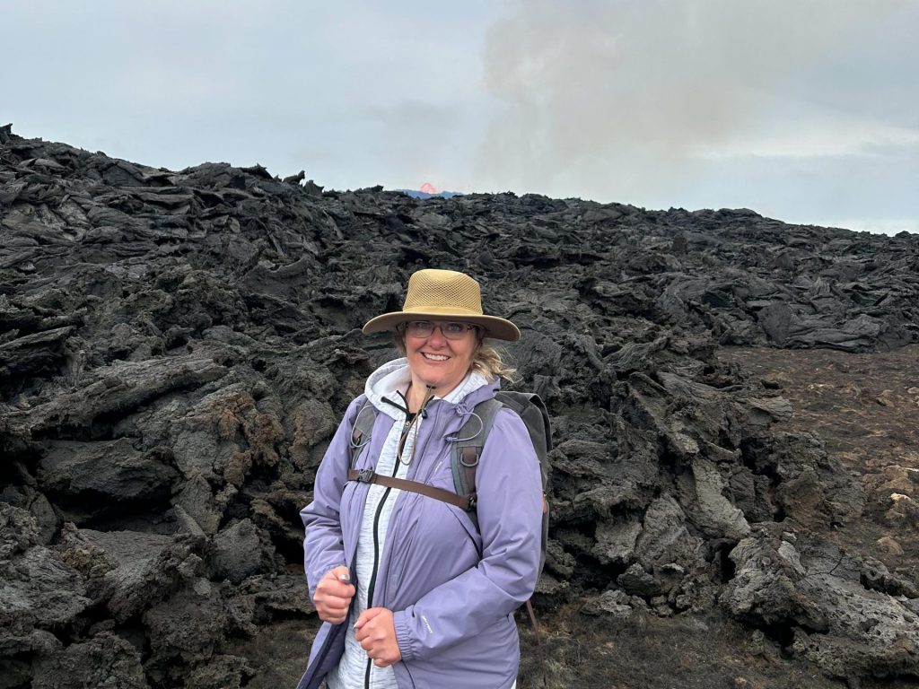 Sara Pearson standing in front of lava rock