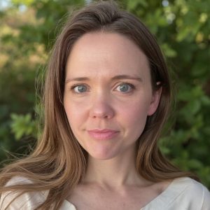 Ashley Quigley with green foliage in the background.