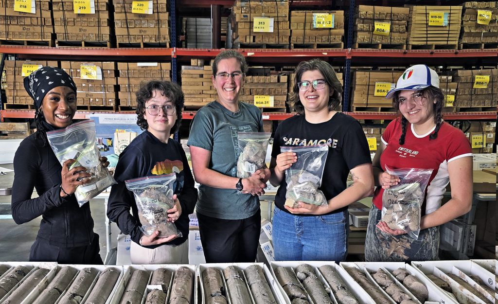 Dr. Schmidt (center) and student researchers from Oberlin college holding sample bags of sediment cores at MGRRE.