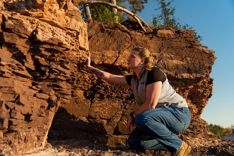 Libby Ives examines the landscape at Presque Isle Park in Marquette, Michigan. (UWM Photo/John Scheibe)