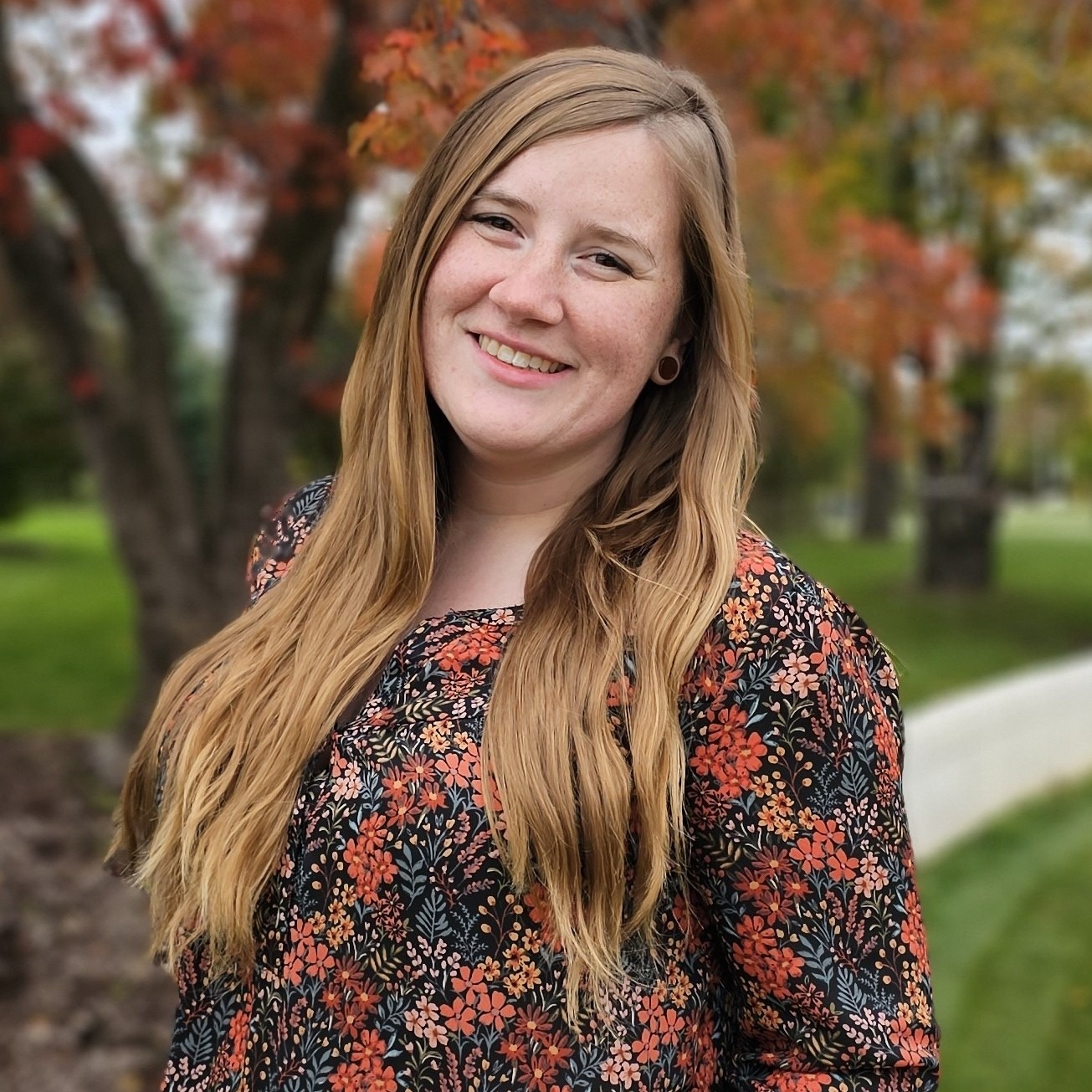 Profile picture of Ashley Scott with a forested background