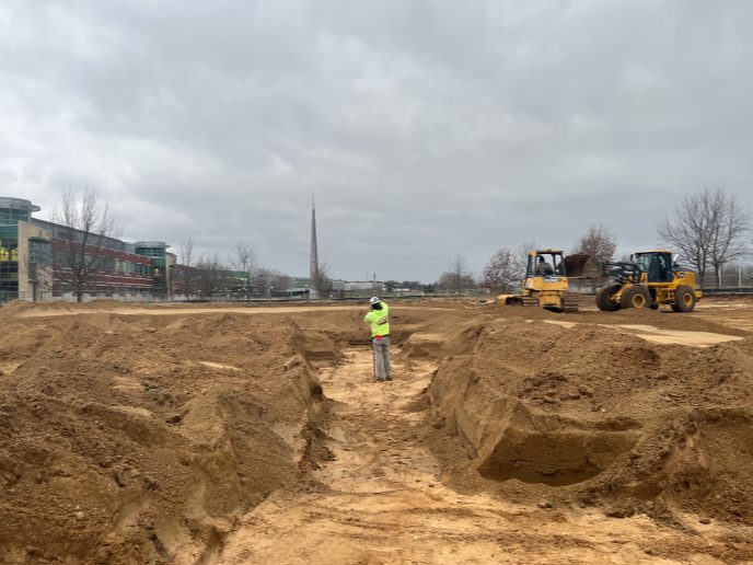 Construction photo of the new MGRRE site showing the subgrade and a construction working standing from afar.